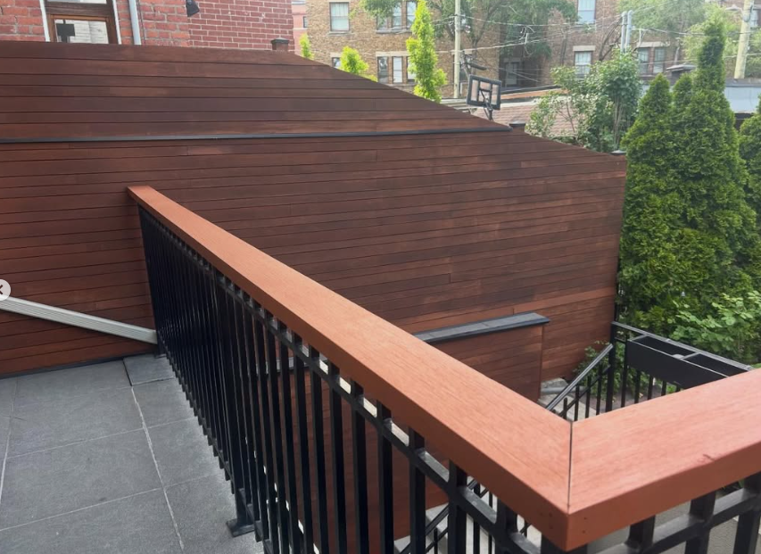 Exterior wood staining project — finished wood cladding and railing